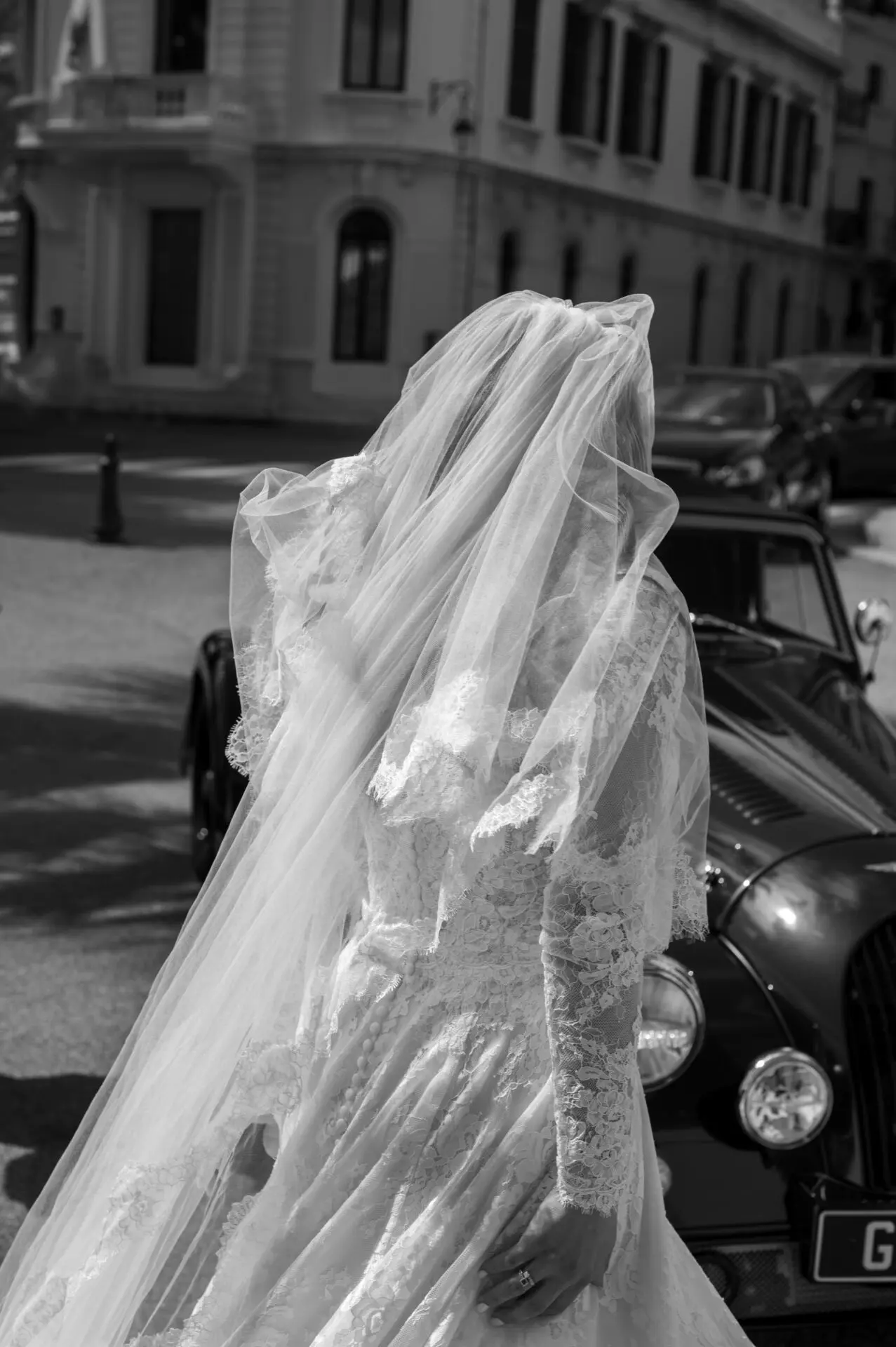 bride with her veil dancing in front of the church