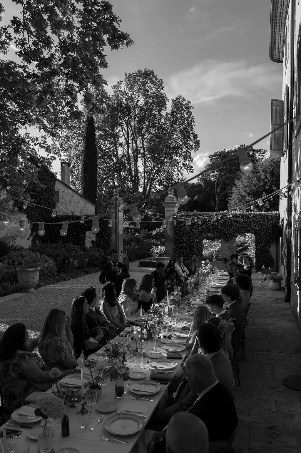 guests setting on the wedding table outside