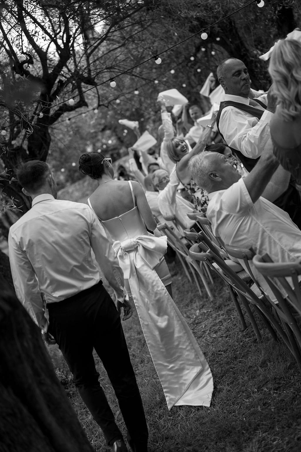 Grasse, French Riviera, France, Mai 2025 bride and groom making their entrance and guests welcoming them with towels dancing