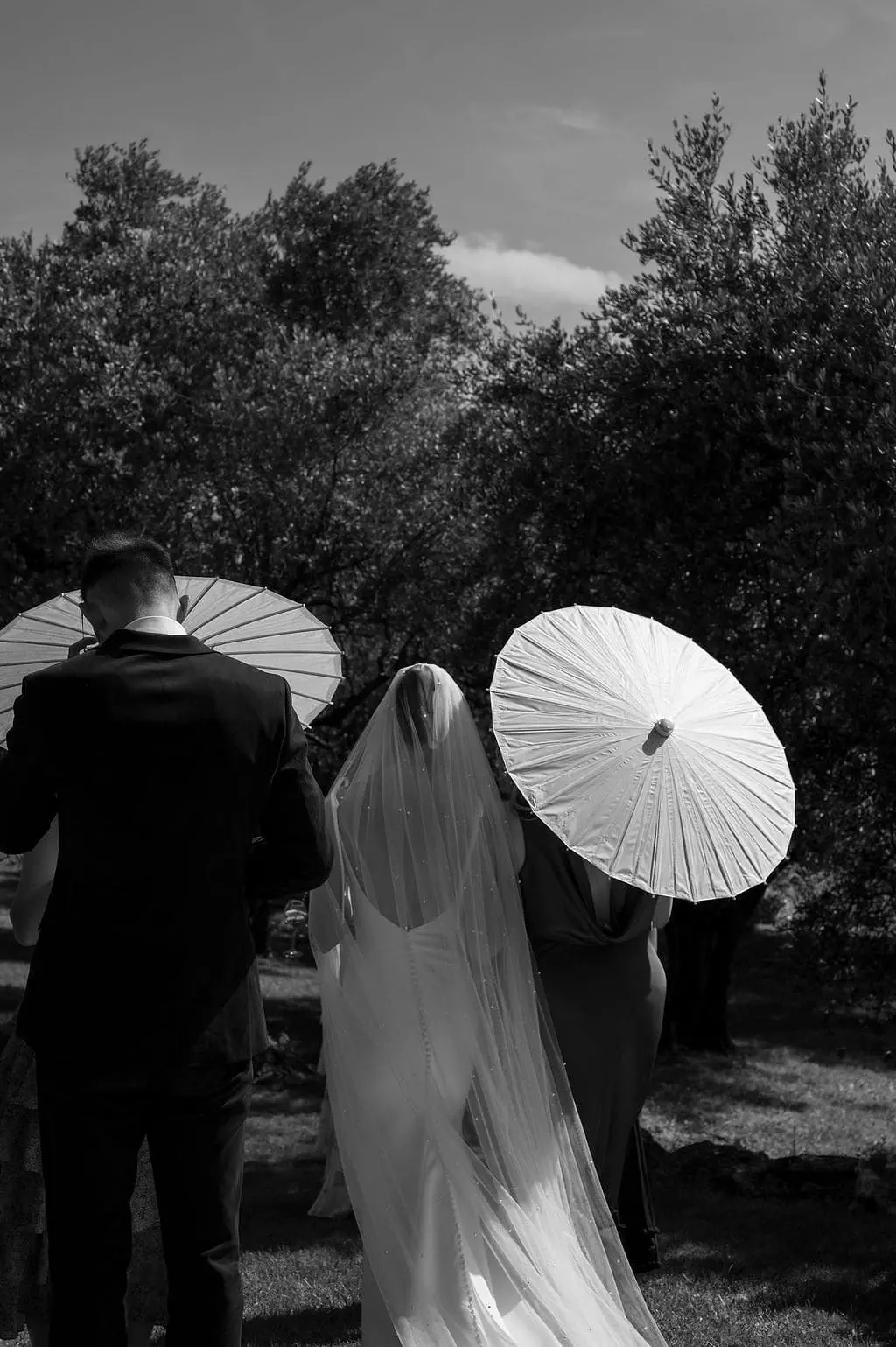 bride and friend with umbrella