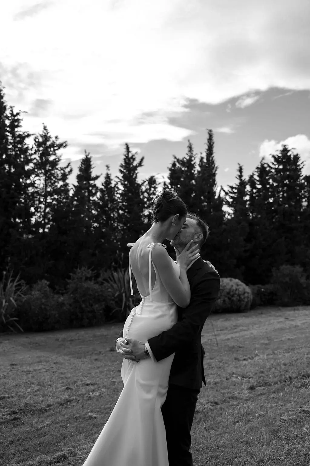 groom holding his bride by the butt
