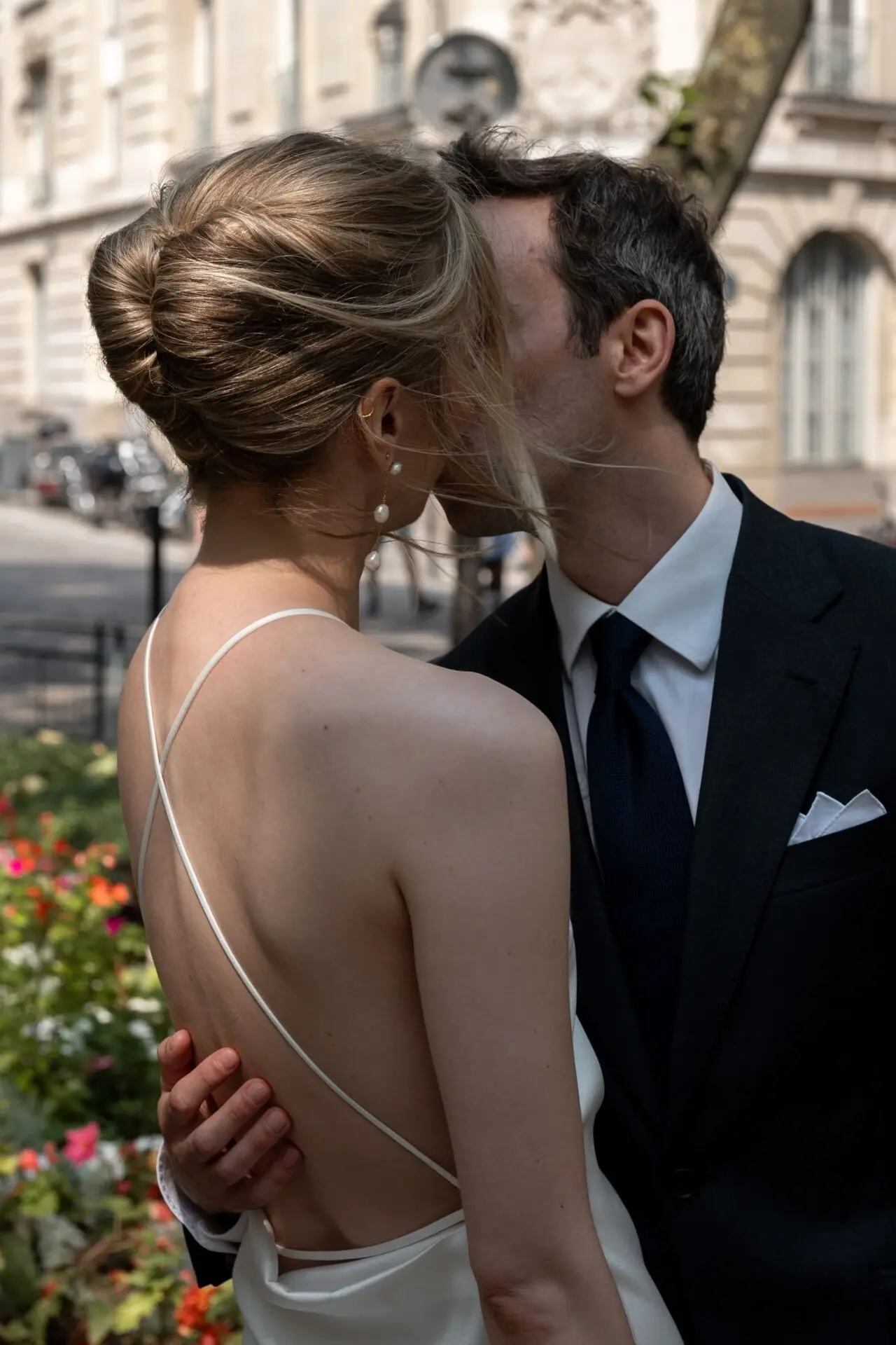 a newly groom kiss is newly bride holding her in the back