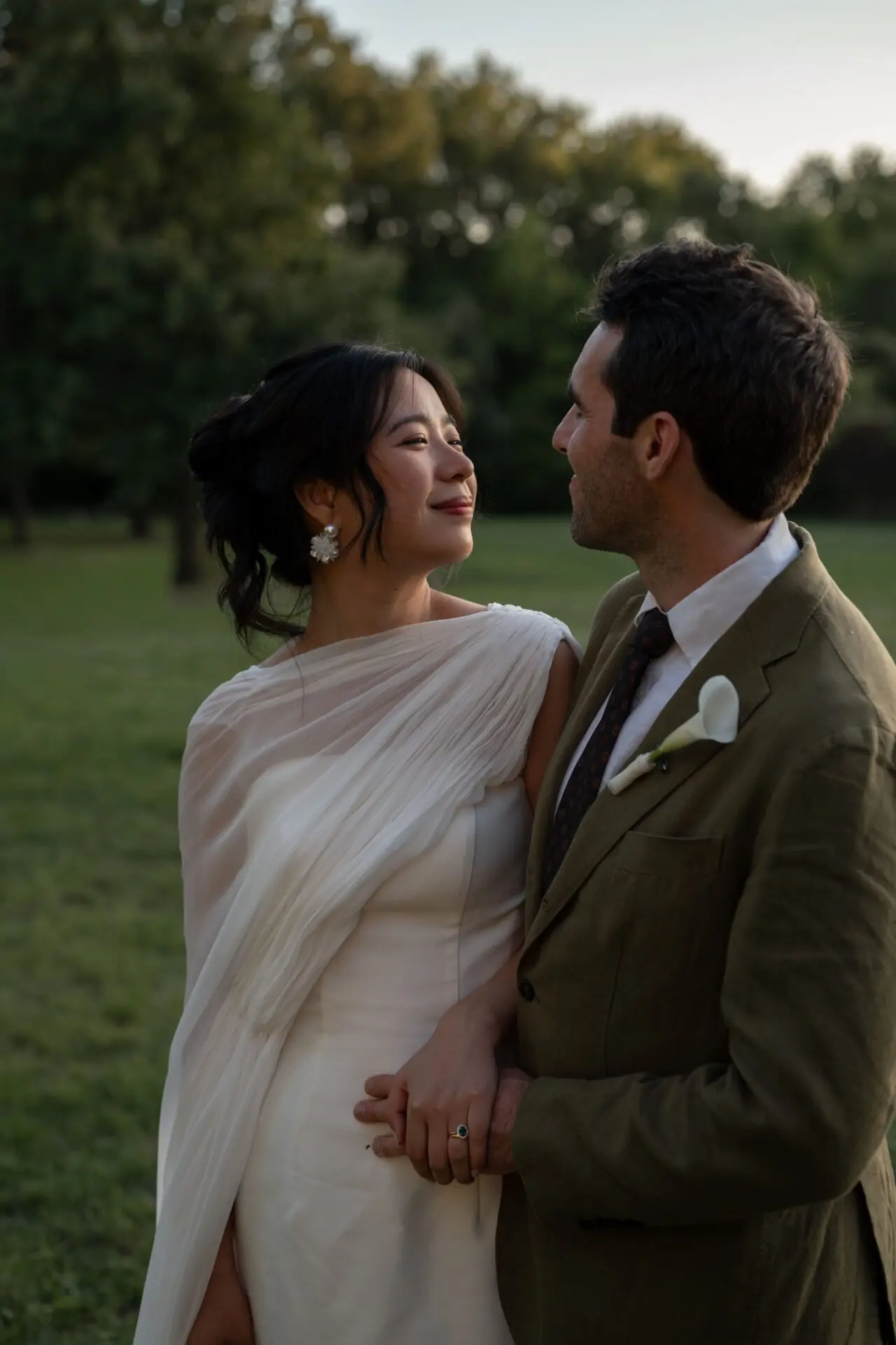 bride and groom looking at each other with tenderness at sunset