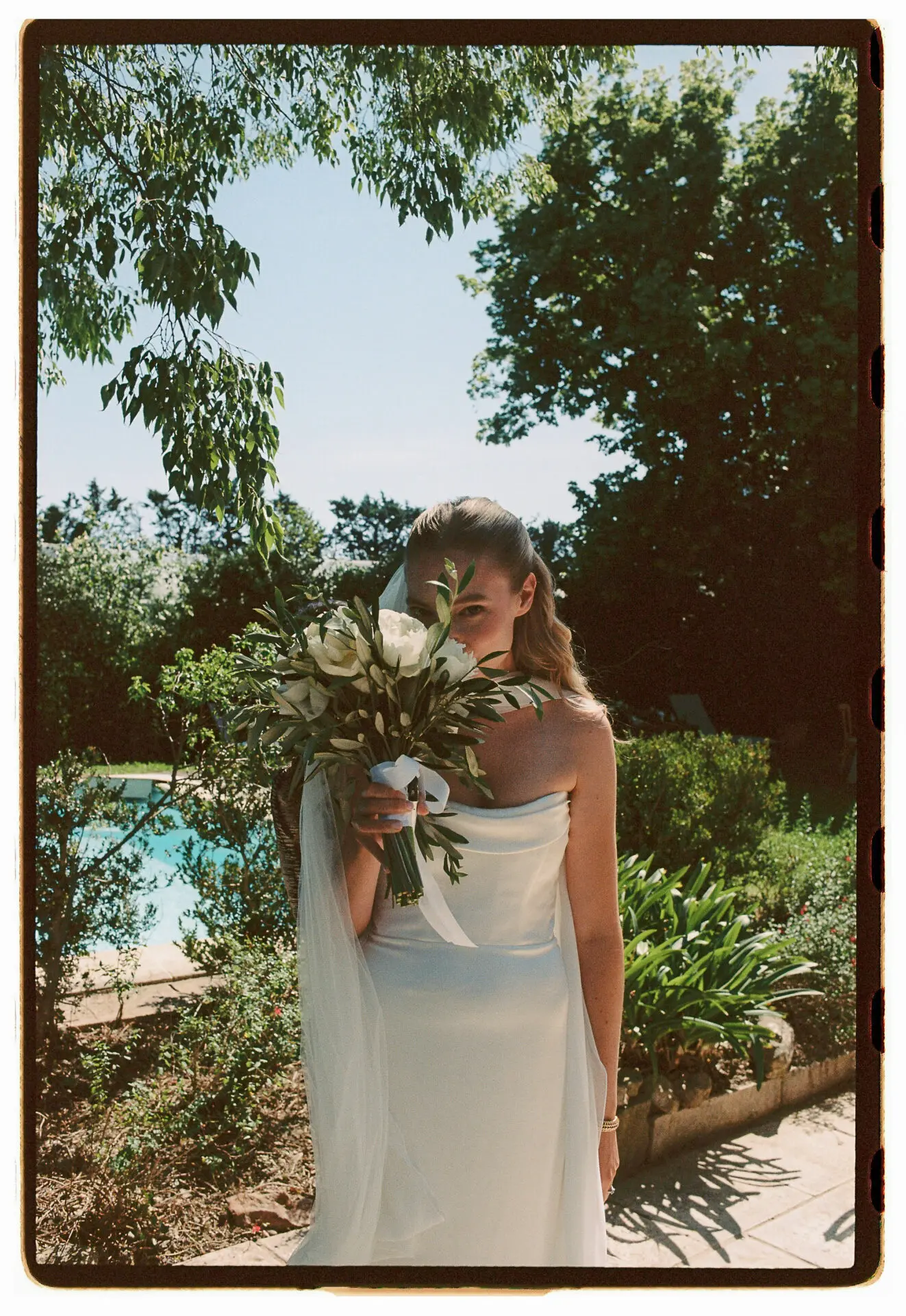 bride and groom kissing on film
